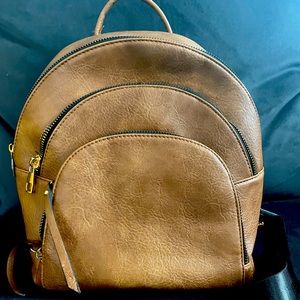 Brown faux leather backpack. Excellent condition.